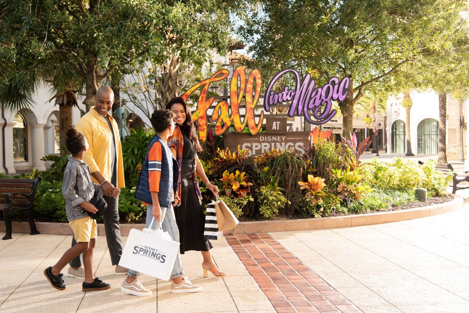 Family shopping together at Disney Springs in the fall